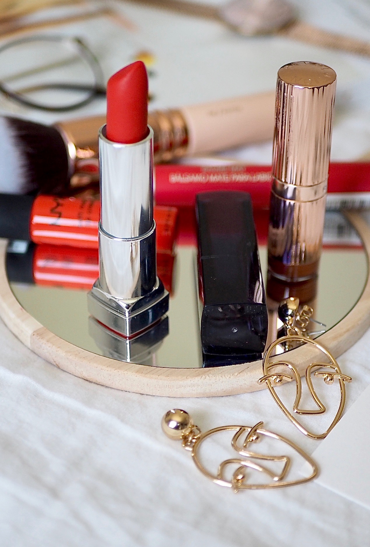 the best orange lipsticks for brightening the complexion and wearing through out the long summer nights.