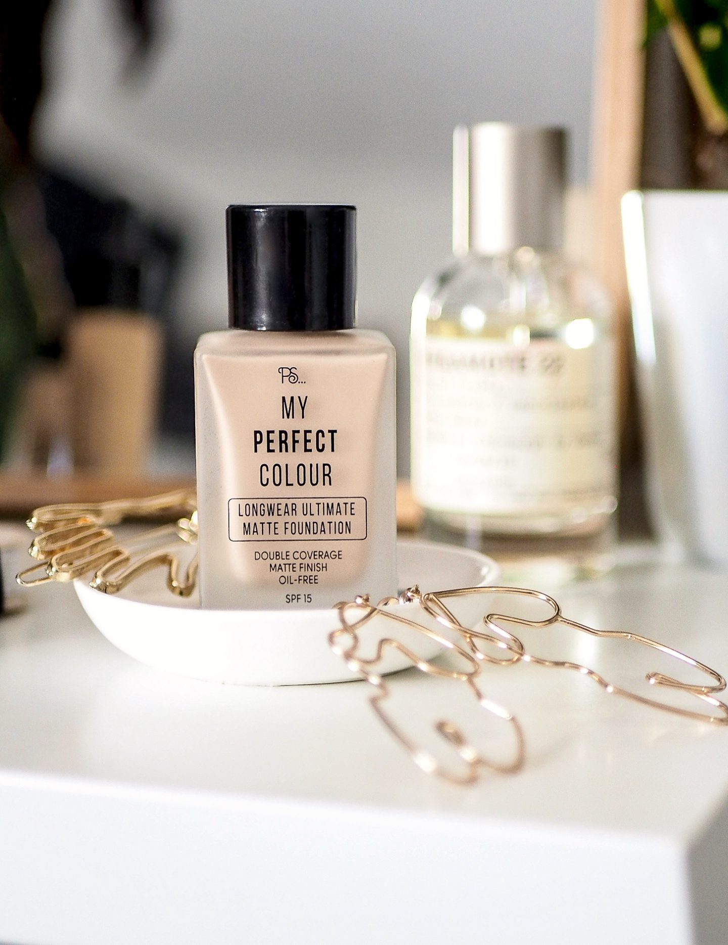 primark longwear matte foundation sitting beside jewellery and perfume