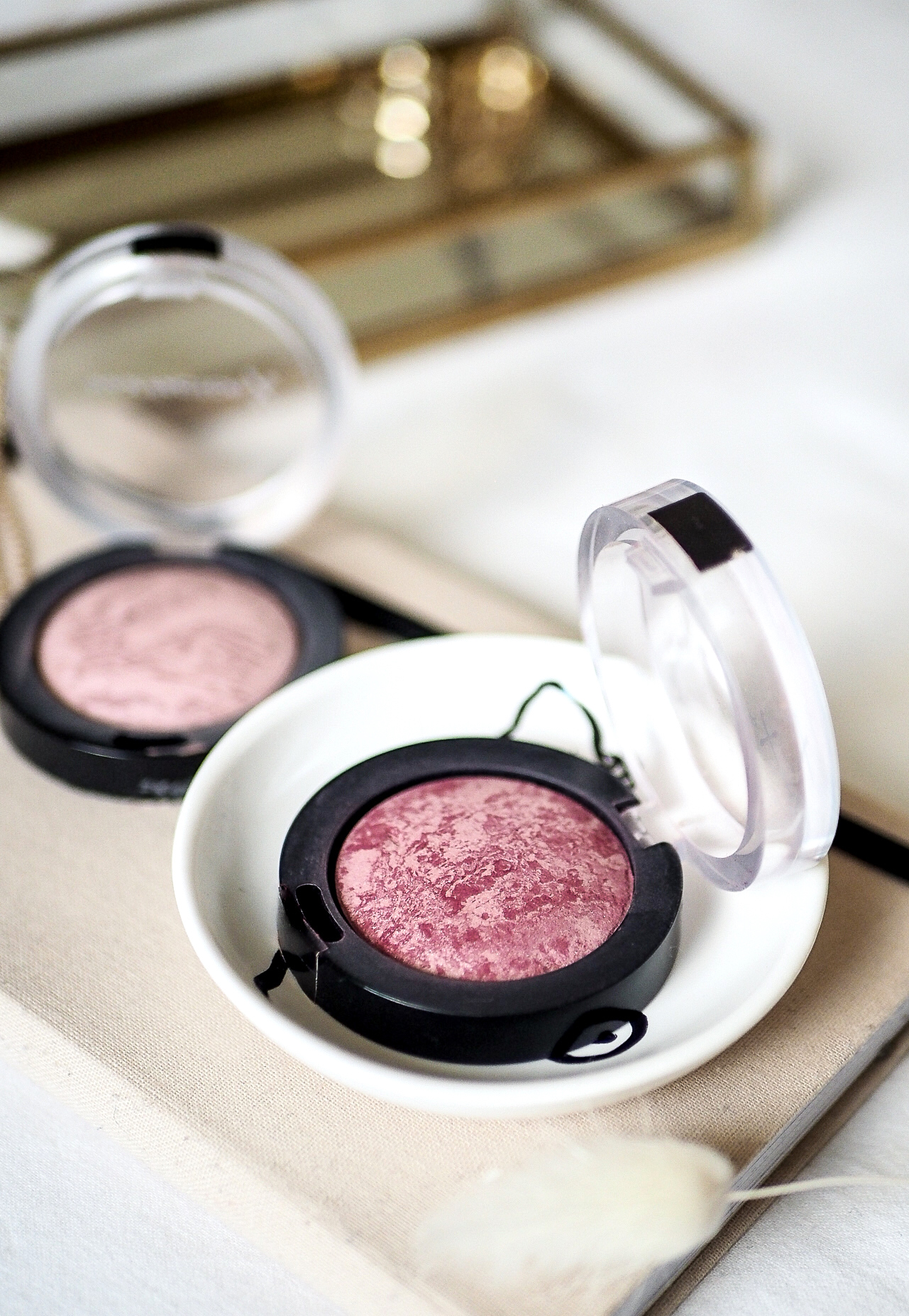 max factor creme puff blushers sitting on notebook with gold tray in background