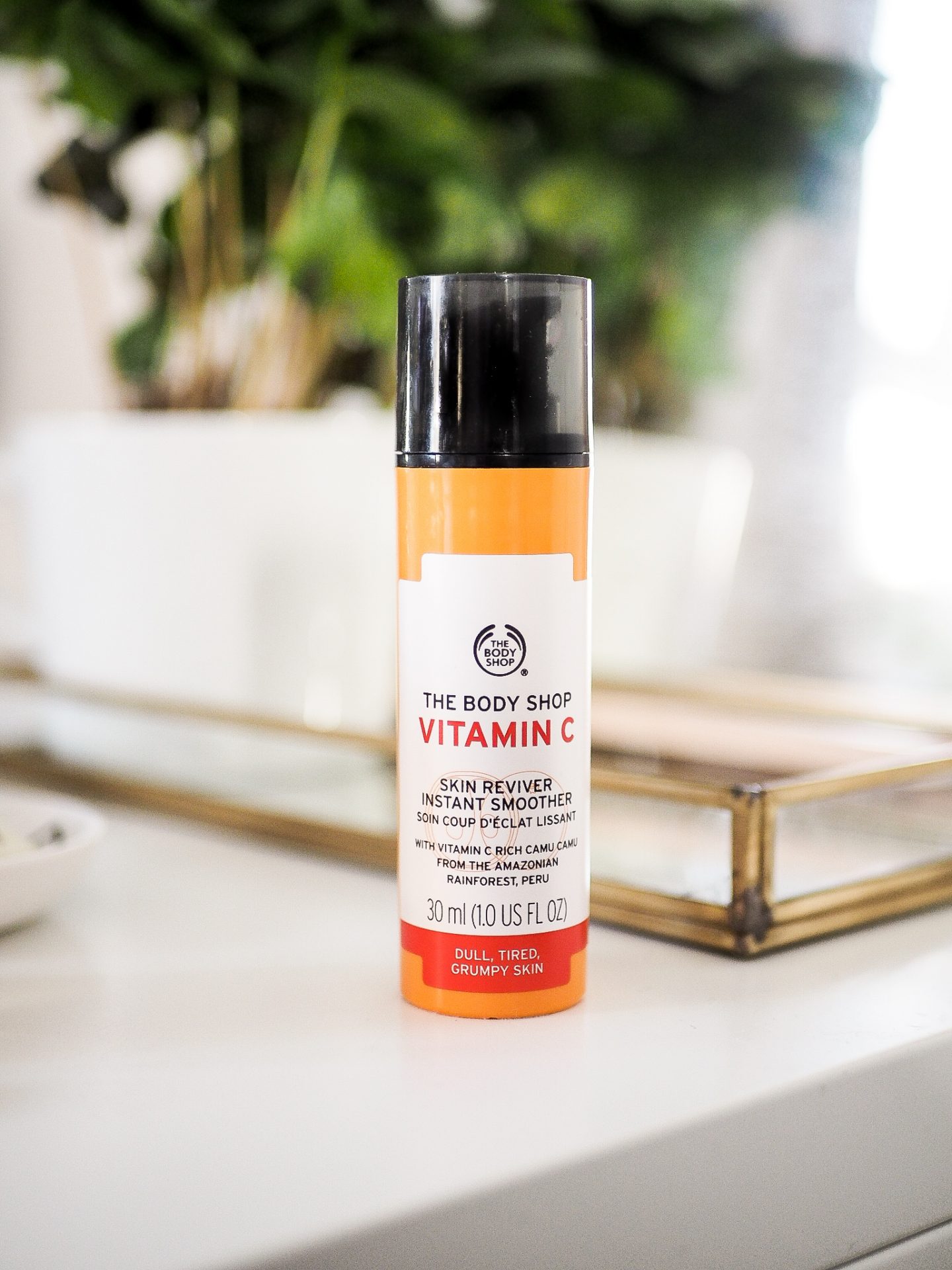 the body shop vitamin c reviver on desk with plant